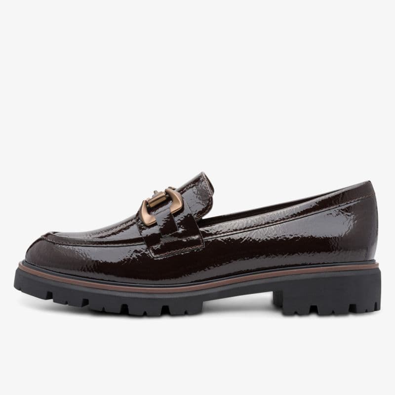Shiny dark brown loafer with a chunky sole and bronze buckle detail on the side, shown on a white background.